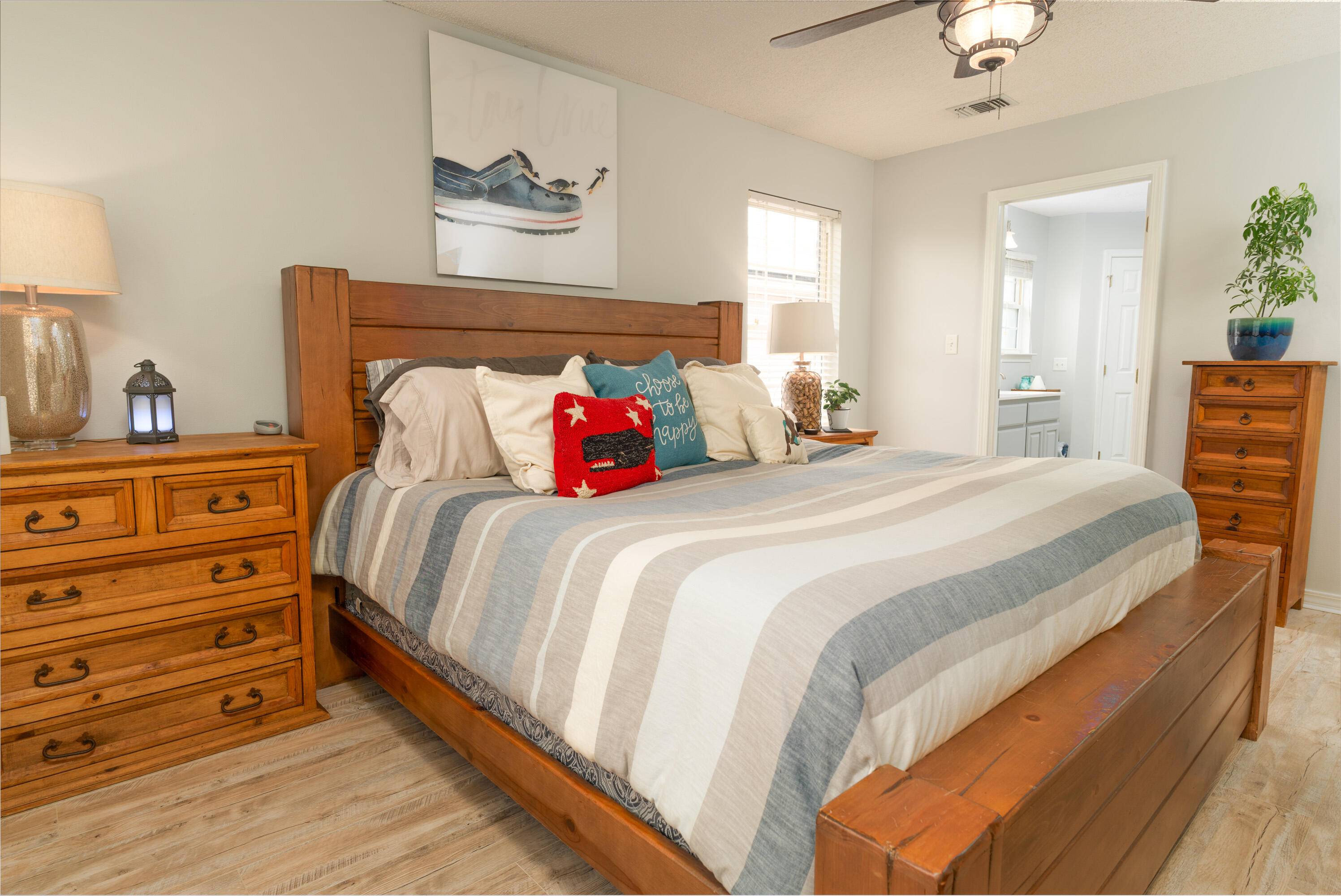 714 Riva Ridge Drive Crestview, FL 32539 - Photo 13 of 37 a bedroom with a bed and a lamp on dresser