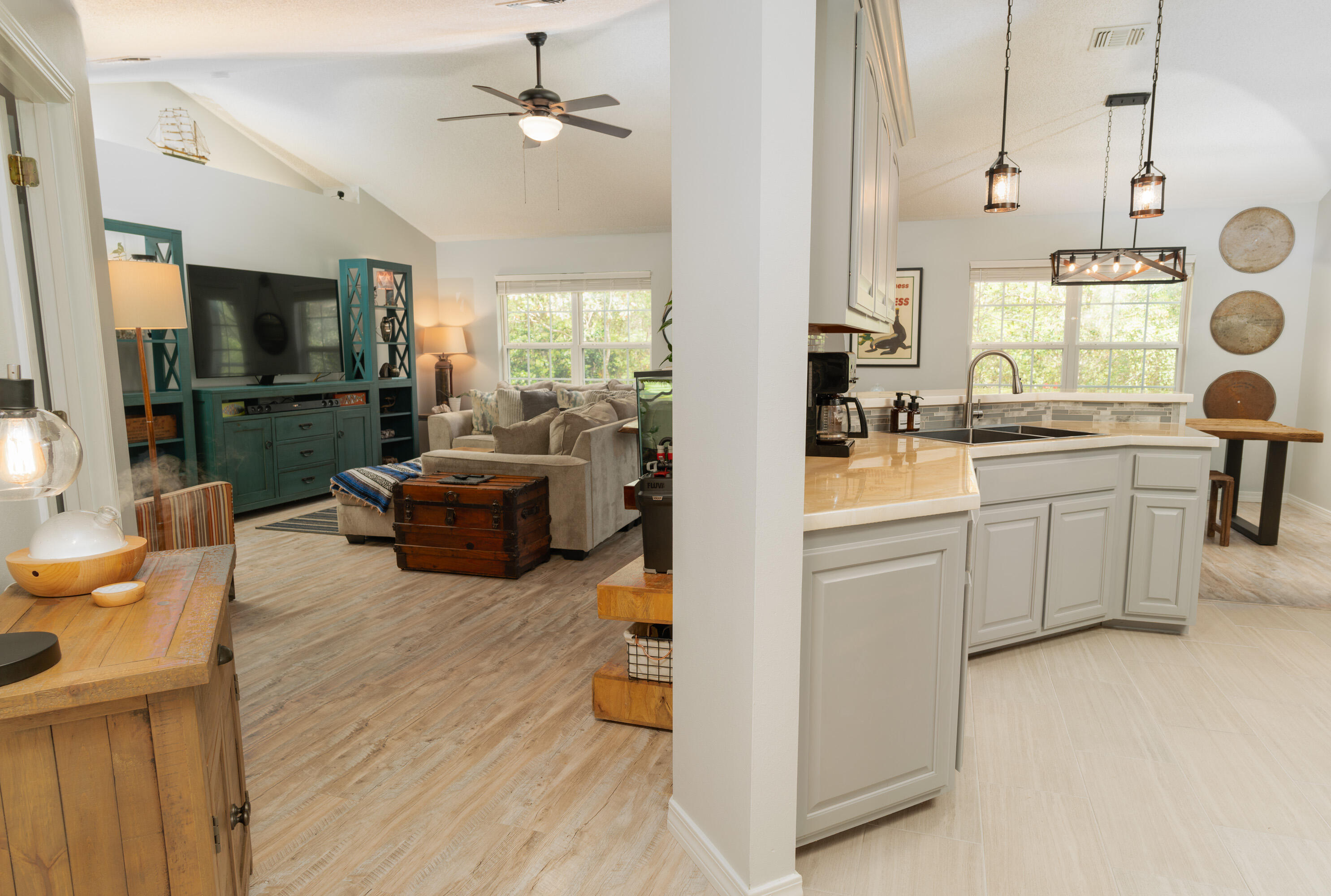 714 Riva Ridge Drive Crestview, FL 32539 - Photo 5 of 37 a living room with furniture a flat screen tv and kitchen view