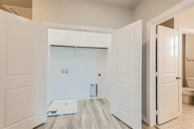 a view of room with closet and wooden floor