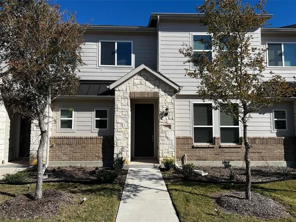 a front view of a house with garage