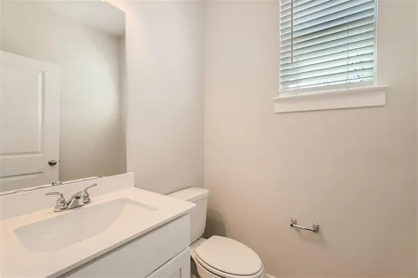 a bathroom with a sink a toilet and mirror