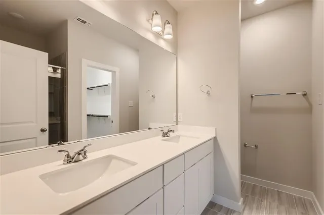 a bathroom with a sink vanity and a mirror