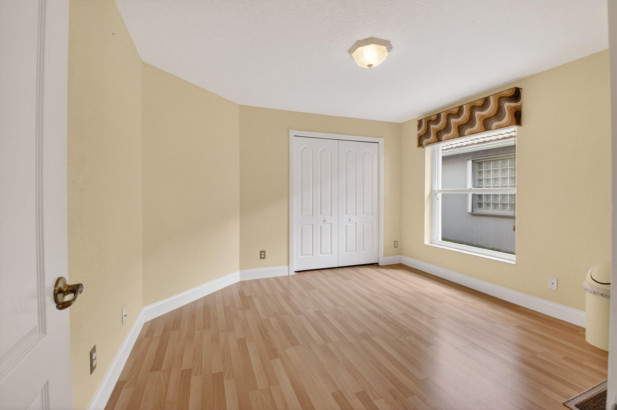 8286 Duomo Circle Boynton Beach, FL 33472 - Photo 35 of 79 a view of an empty room with wooden floor and a window
