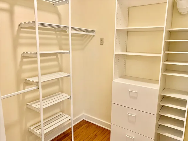 a view of walk in closet with empty racks