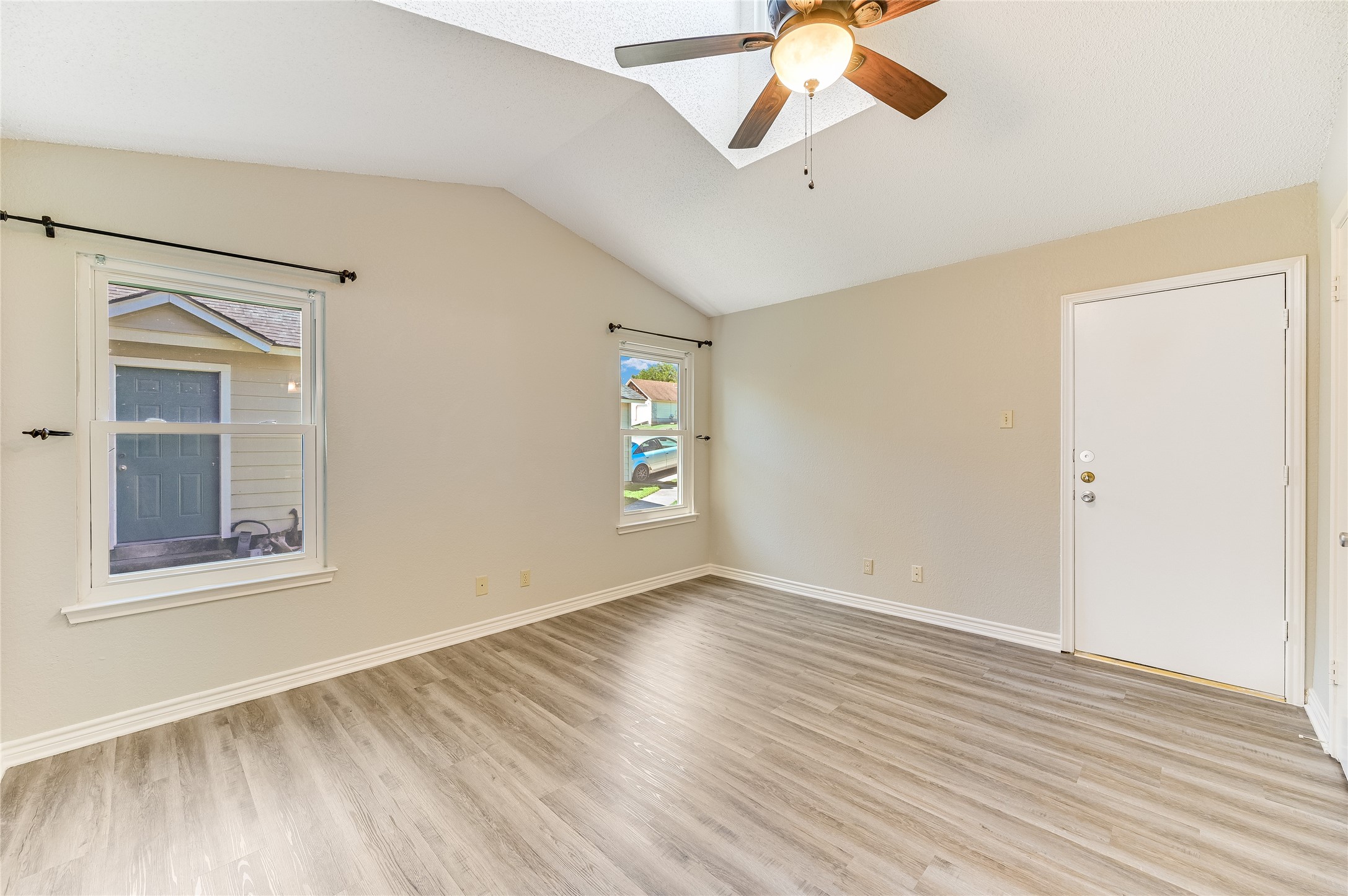 526 Cutty Trail, Unit B Lakeway, TX 78734 - Photo 7 of 10 Vaulted ceiling living space with wood-finish flooring
