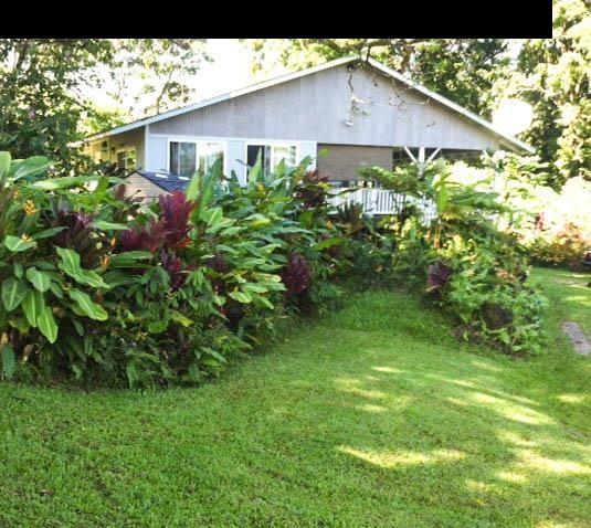 1010 Nahiku Road Hana, HI 96713 - Photo 11 of 13 a view of a house with a yard and garden