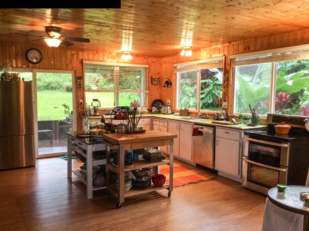 1010 Nahiku Road Hana, HI 96713 - Photo 2 of 13 a kitchen with a stove a sink and wooden floor