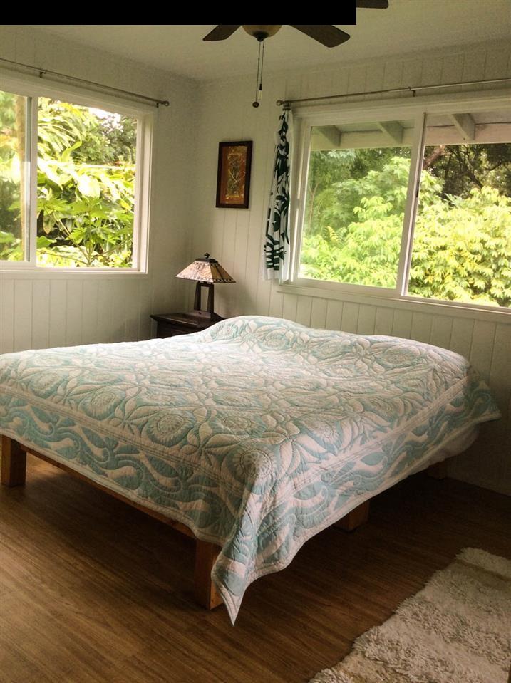 1010 Nahiku Road Hana, HI 96713 - Photo 7 of 13 a bed sitting in a bedroom next to a window