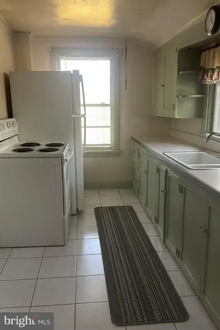 a kitchen with a refrigerator and a sink