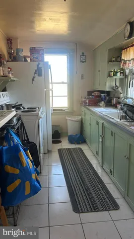 a kitchen with a cabinets and wooden floor
