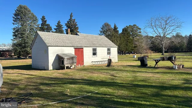 a house view with swimming pool in front of it