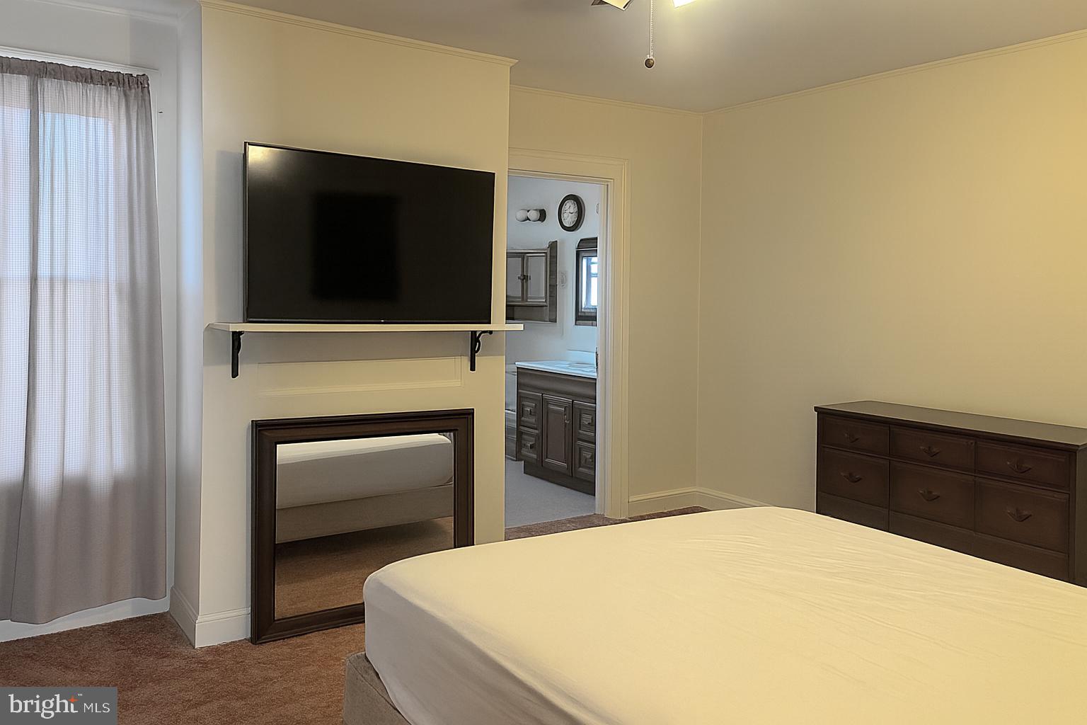 295 North North Main Street Manahawkin, NJ 08050 - Photo 8 of 17 a bedroom with a bed and a television