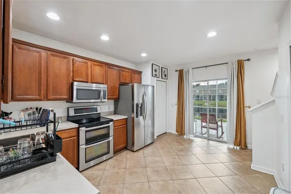 a kitchen with stainless steel appliances large cabinets and a stove top oven