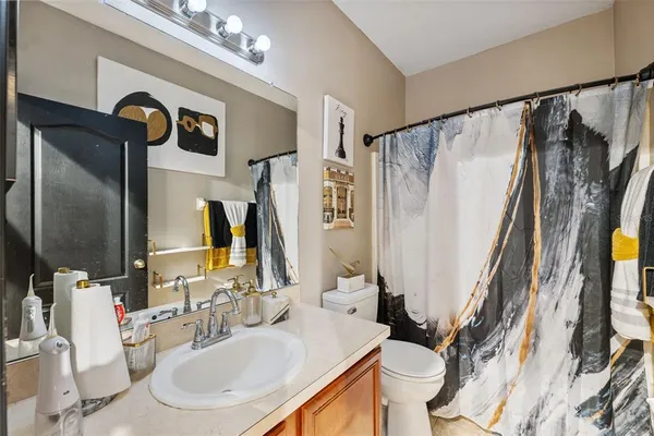 a bathroom with a sink a toilet and a mirror