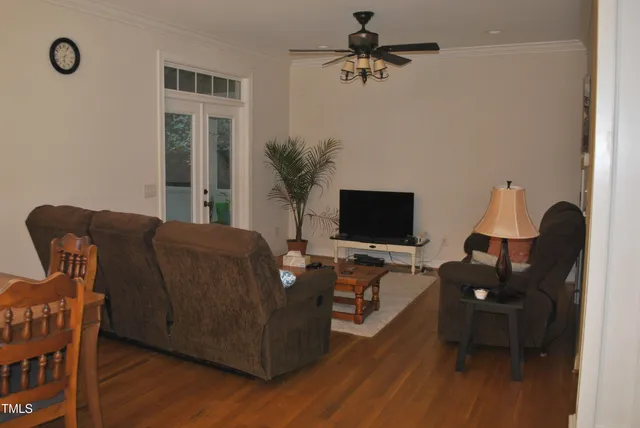 a living room with furniture wooden floor and a chandelier