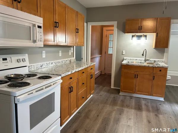 a kitchen with stainless steel appliances a stove a sink and a microwave