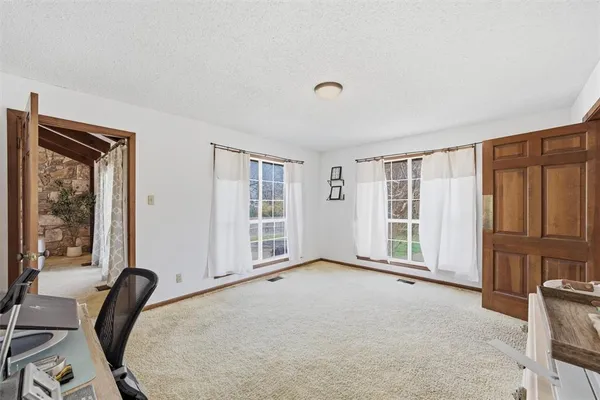 a view of a livingroom with a furniture and large window