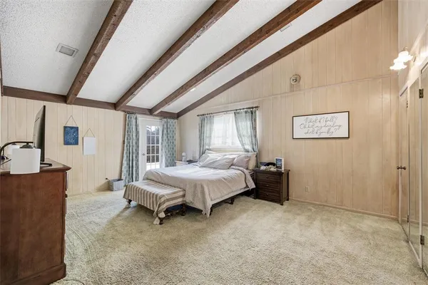 a spacious bedroom with a bed and a cabinets