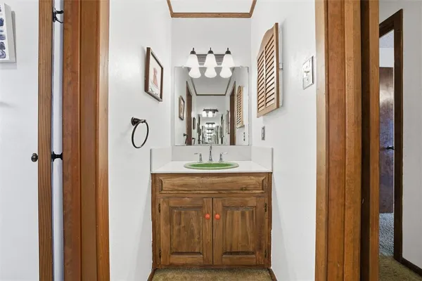 a bathroom with a granite countertop sink a mirror and a shower curtain