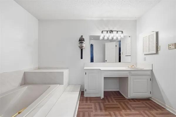 a spacious bathroom with a sink and a mirror