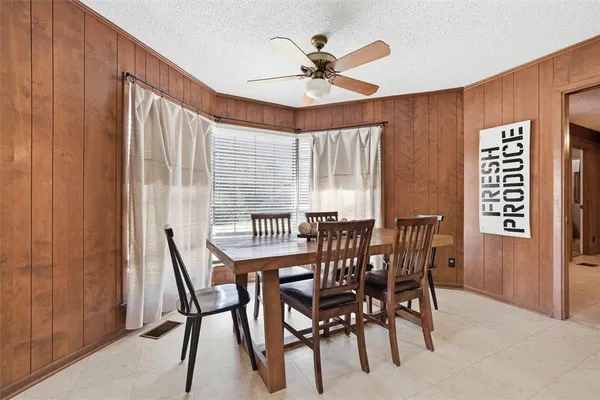 a view of a dining room with furniture and window