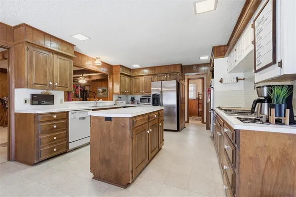 a kitchen with stainless steel appliances a sink stove and cabinets