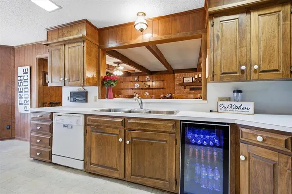 a kitchen with a sink cabinets and wooden floor