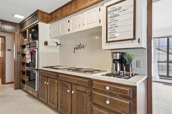 a kitchen with stainless steel appliances granite countertop a stove and a refrigerator