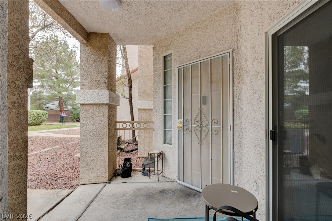 8555 West Russell Road, Unit 1017 Las Vegas, NV 89113 - Photo 19 of 34 A welcoming covered patio offers a private outdoor retreat with security features.