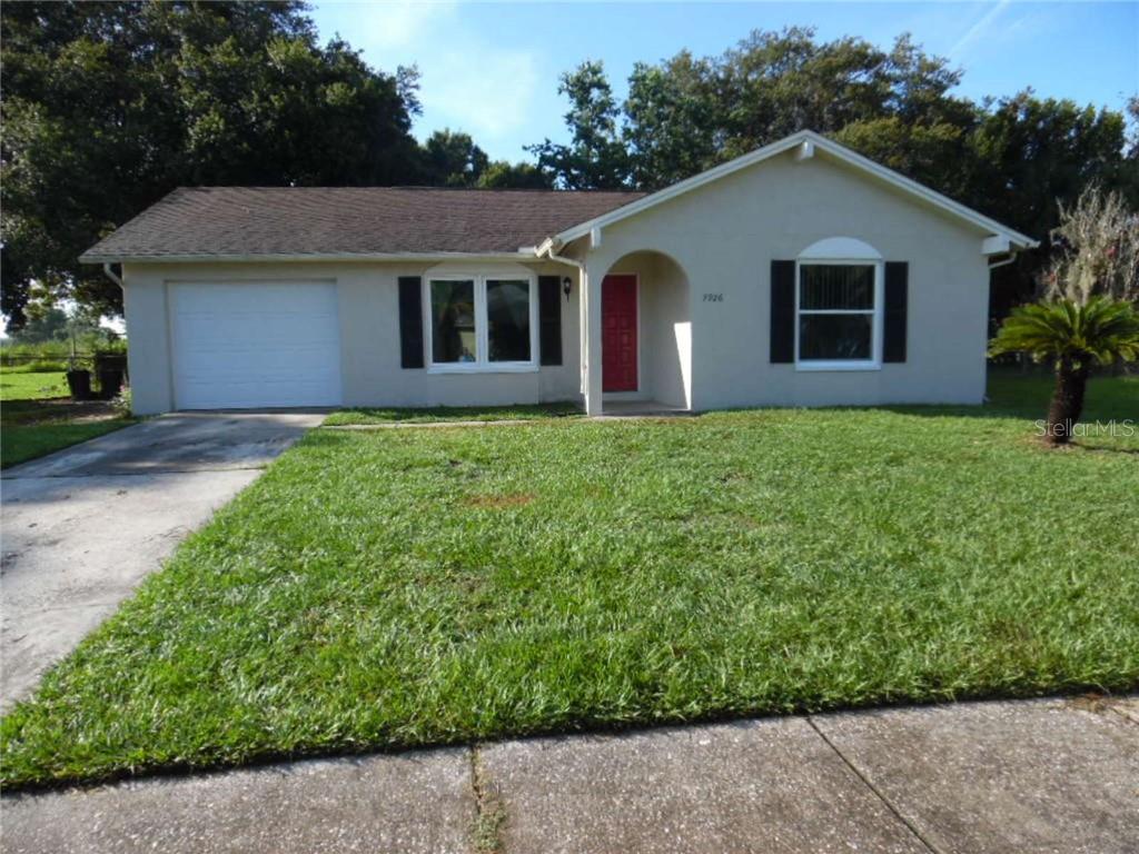 7926 Aden Loop New Port Richey, FL 34655 - Photo 1 of 1 a front view of a house with a yard
