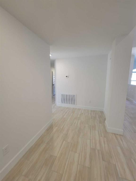 7035 Southwest 131st Loop Ocala, FL 34473 - Photo 15 of 28 a view of an empty room and wooden floor