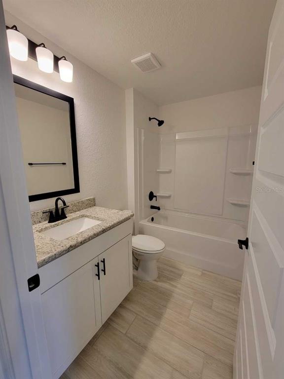 7035 Southwest 131st Loop Ocala, FL 34473 - Photo 22 of 28 a bathroom with a granite countertop sink toilet and shower