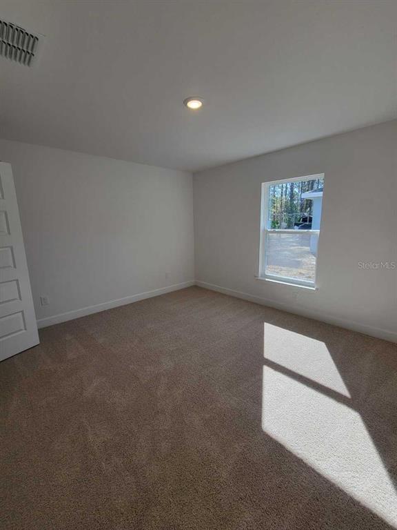 7035 Southwest 131st Loop Ocala, FL 34473 - Photo 23 of 28 an empty room with windows