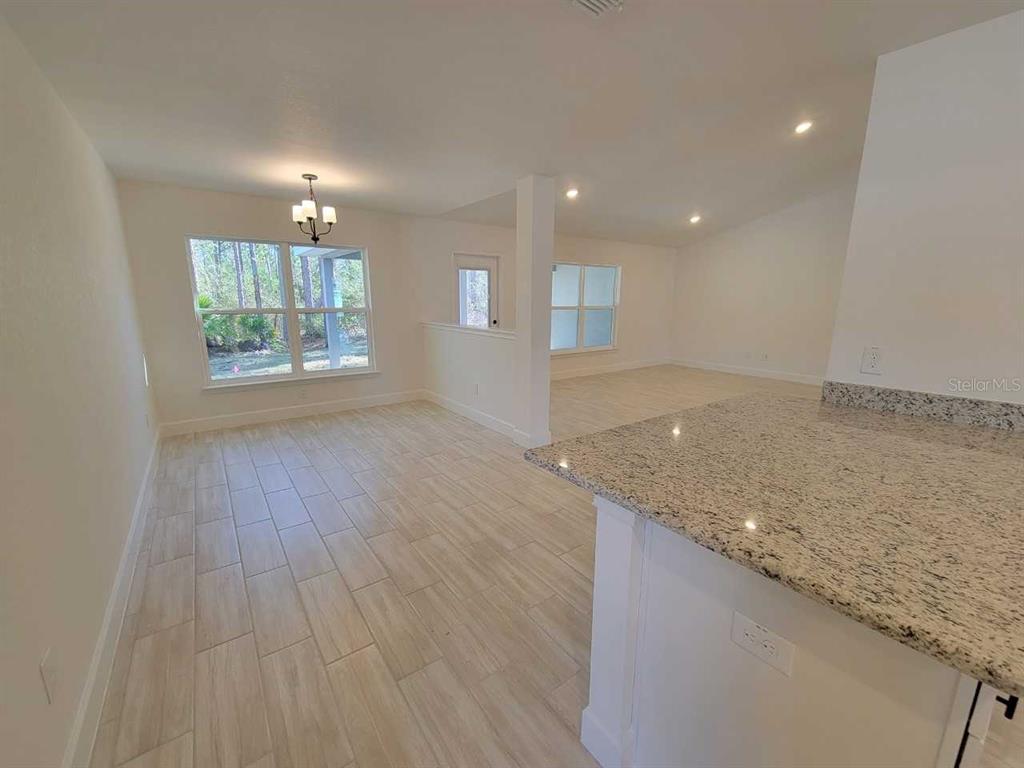 7035 Southwest 131st Loop Ocala, FL 34473 - Photo 10 of 28 an empty room with wooden floor and windows