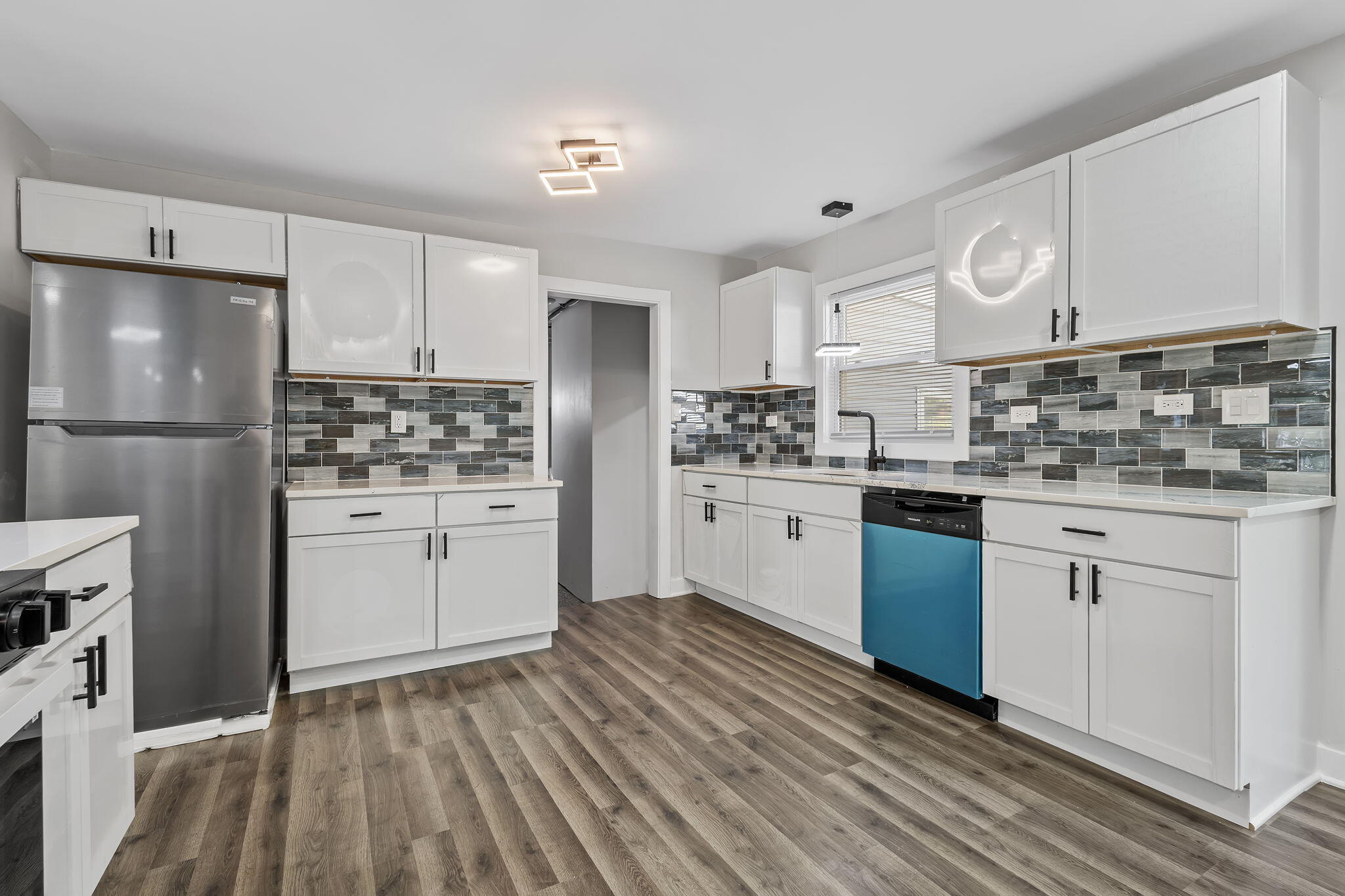 2368 Wheeler Street Gary, IN 46406 - Photo 4 of 16 a kitchen with white cabinets and white appliances