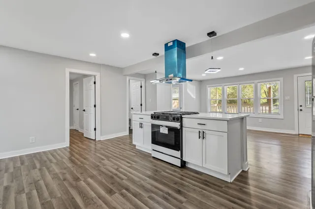 a kitchen with stainless steel appliances a stove top oven and sink