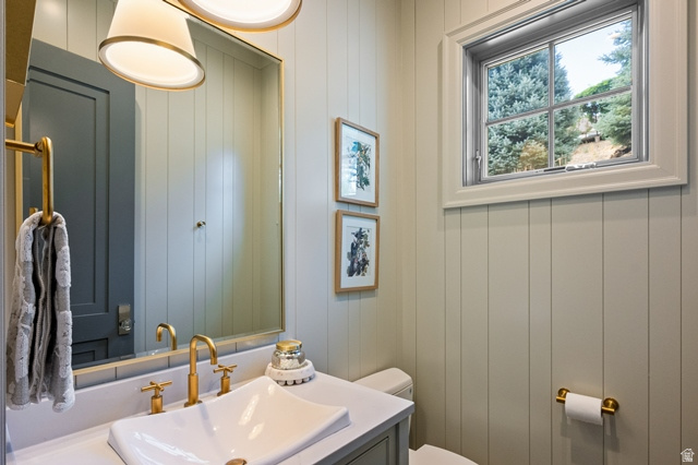 3 Carriagewood Cove, Unit 1088 Sandy, UT 84092 - Photo 26 of 79 Board and batten wall paneling, vanity with a rectangular vessel sink, gold-finish faucet and hardware, two pendant light fixtures, and a window with exterior tree scenery