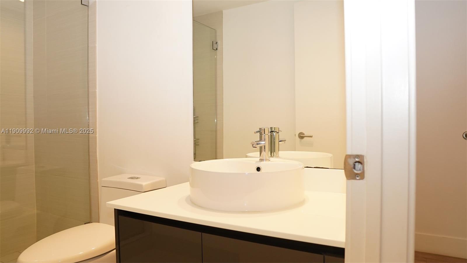 31 Southeast 6th Street, Unit 1108 Miami, FL 33131 - Photo 12 of 22 a bathroom with a sink and a toilet