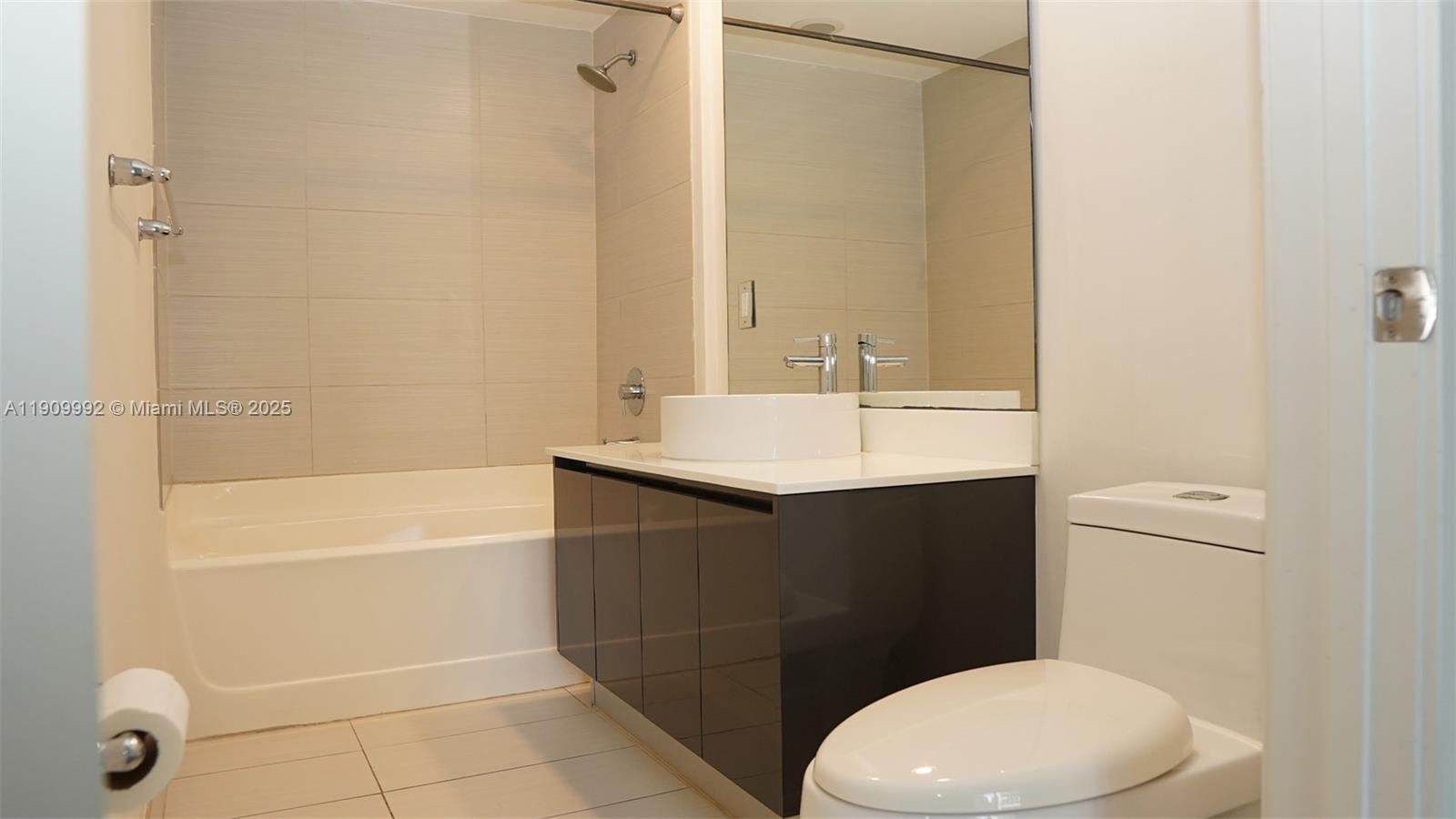 31 Southeast 6th Street, Unit 1108 Miami, FL 33131 - Photo 13 of 22 a bathroom with a sink a toilet and shower