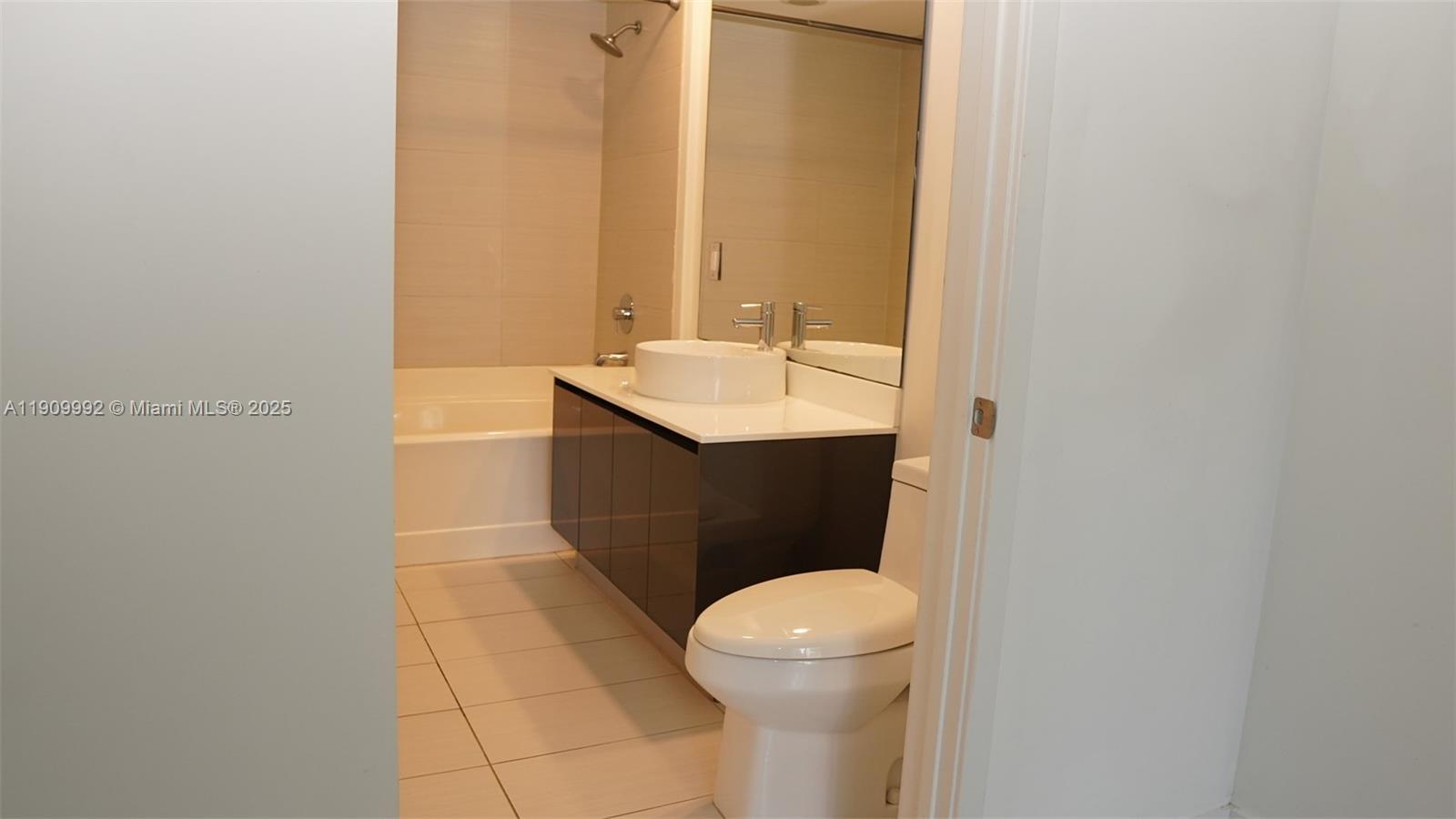 31 Southeast 6th Street, Unit 1108 Miami, FL 33131 - Photo 14 of 22 a bathroom with a sink and a toilet