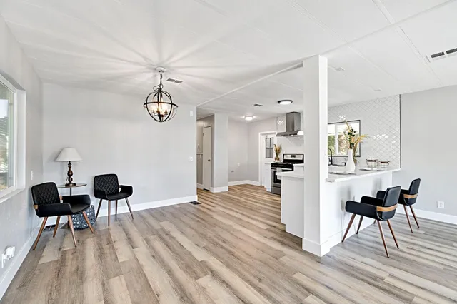 a view of a dining room with furniture and wooden floor