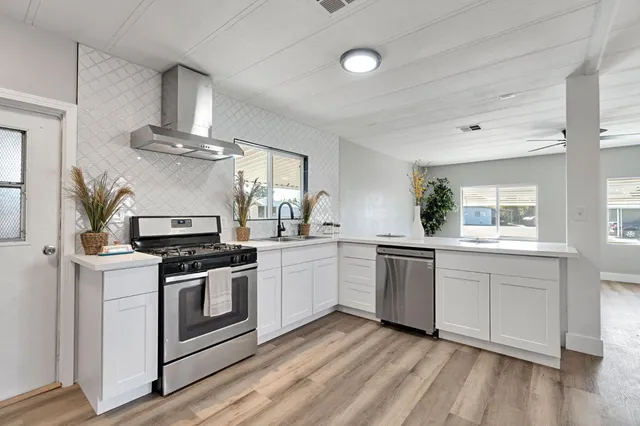 a kitchen with a stove top oven sink and cabinets