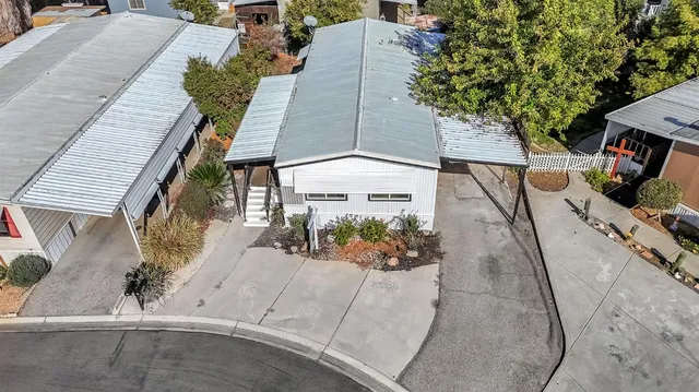 an aerial view of a house with a yard