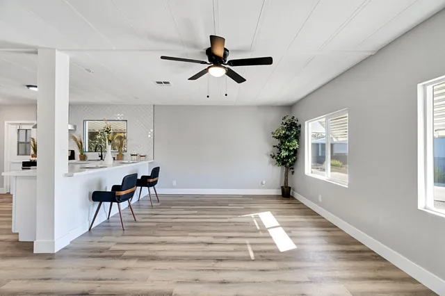 a view of a livingroom with a window and wooden floor
