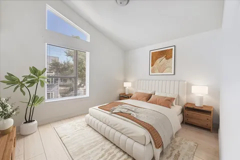 a bedroom with a bed and a potted plant