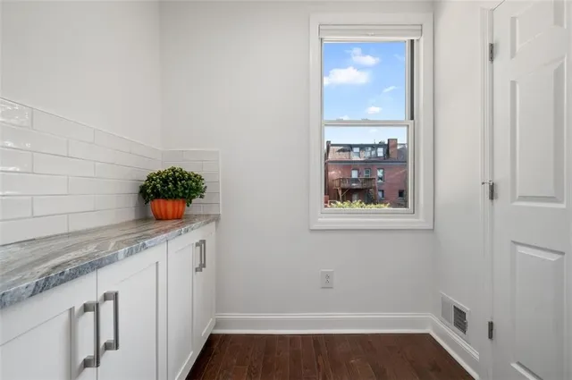 a view of entryway and hall with wooden floor