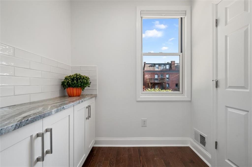5531 Columbo Street Pittsburgh, PA 15206 - Photo 13 of 34 a room with wooden floor and potted plant