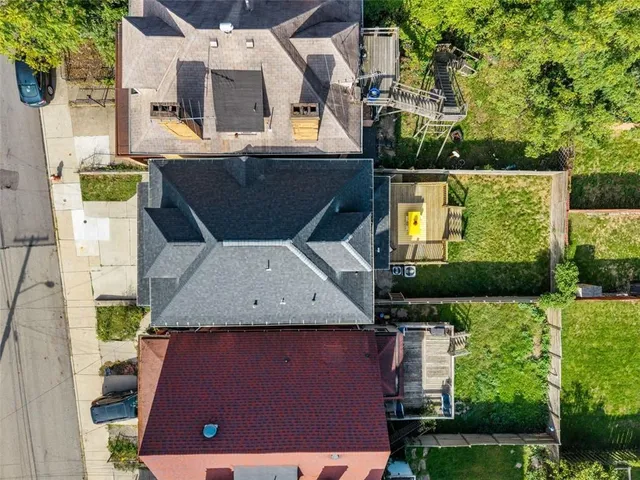 an aerial view of a house with yard