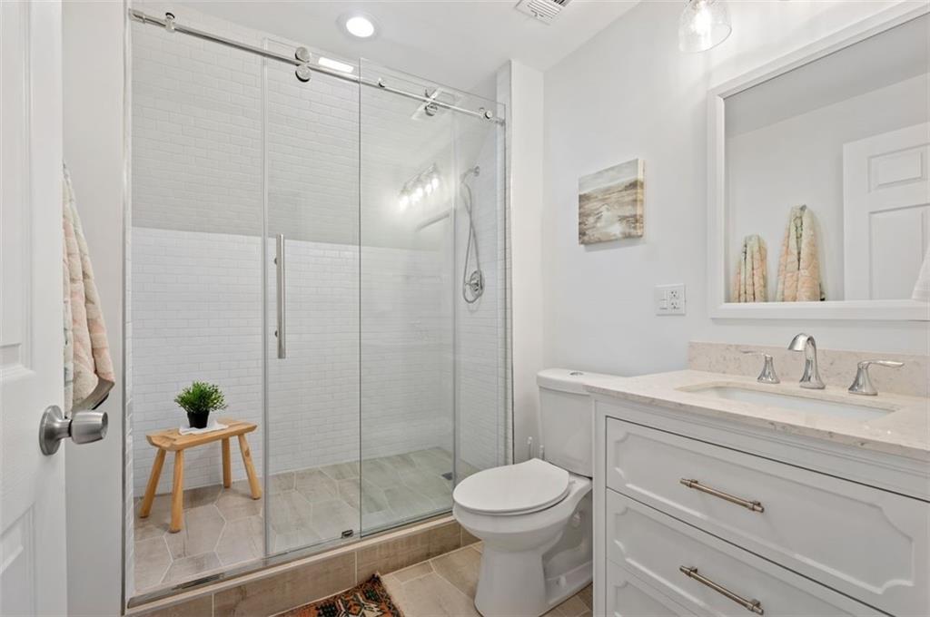 5531 Columbo Street Pittsburgh, PA 15206 - Photo 26 of 34 a bathroom with a shower sink vanity mirror and toilet