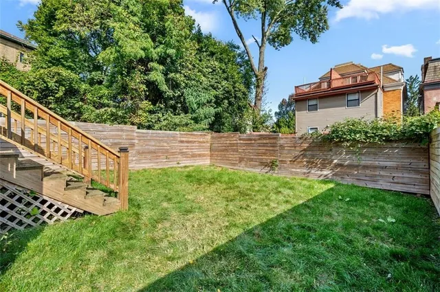 an aerial view of multiple houses with yard